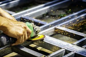 Man's hand grinding steel construction photo