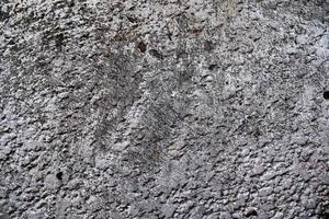 Detailed view on aged concrete walls with cracks and a lot of structure in high resolution photo