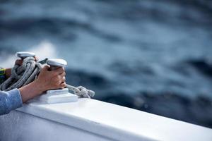 children hands while holding boat bollard photo