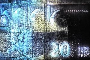 Illustration of glowing euro banknotes with a green kirlian aura around them. photo