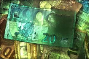 Illustration of glowing euro banknotes with a green kirlian aura around them. photo