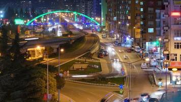 Luces nocturnas brillantes de 8k y tráfico de vehículos en el centro de la ciudad llena de gente video