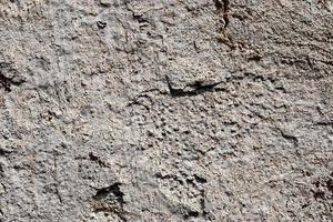 Detailed view on aged concrete walls with cracks and a lot of structure in high resolution photo