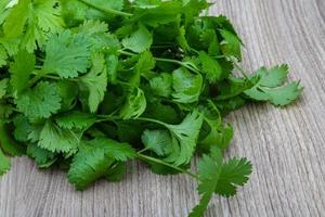 Coriander leaves on wooden background photo