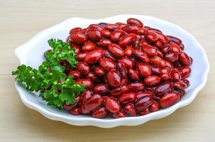 Baked beans in a bowl on wooden background photo