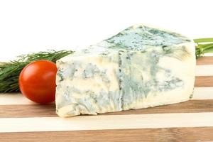 Wedge of soft blue cheese, isolated on white photo
