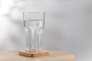 Pure water in the glass is on the table photo