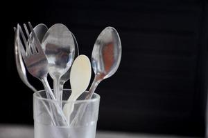 spoon placed in a glass cup on a black background photo