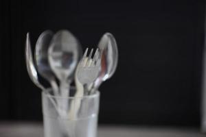 spoon placed in a glass cup on a black background photo