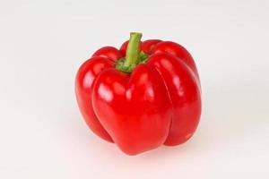 Ripe red bell pepper isolated on white photo