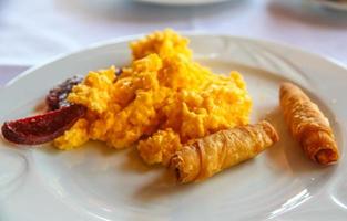 Scrambled eggs on the plate and white background photo