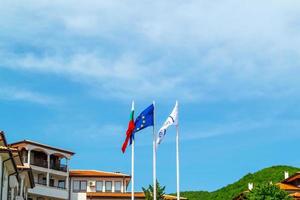 Flag of Bulgaria and European Union waving with the wind above villas photo