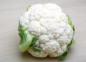 Cauliflower on wooden background photo