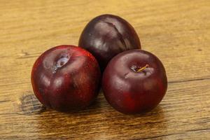 Ripe sweet plum fruit heap photo