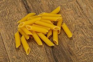 Raw penne pasta for bowl photo