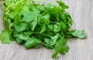 Coriander leaves on wooden background photo