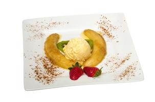 Dessert of banana, ice-cream, caramel, strawberry and mint photo