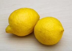 Lemons on wooden background photo