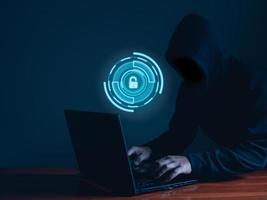 Hackers work on laptops in the dark. The concept of information security in the Internet network and information espionage. photo