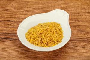 Vegetarian cuisine - dry bulgur for cooking photo