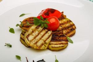 Grilled vegetables on the plate and wooden background photo