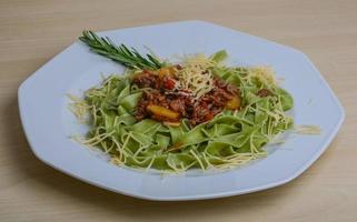 Spaghetti Bolognese on the plate and wooden background photo