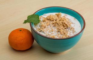 Cornflakes in a bowl on wooden background photo