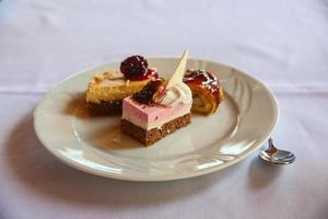 Mini cakes on the plate and white background photo