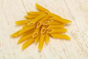 Raw penne pasta for bowl photo