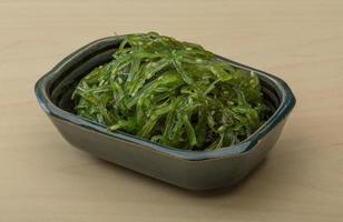 Chuka salad in a bowl on wooden background photo