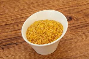 Vegetarian cuisine - dry bulgur for cooking photo