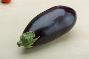 Eggplant on wooden background photo