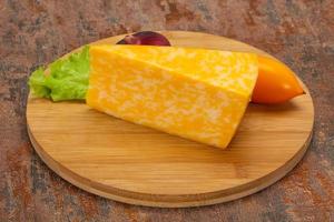 Marble cheese  triangle over wooden photo