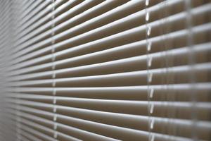 Blinds in office. Interior details. Window is closed from light. Protection from spicy sunlight. photo