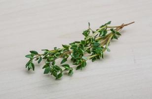 Thyme on wooden background photo