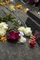 Laying flowers on tombstone. Flowers at ceremony. Grave of inexhaustible soldier in Russia. photo