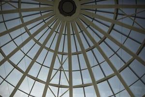 Dome roof made of glass and fittings. Steel beams form circle. photo