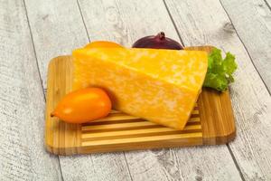 Marble cheese  triangle over wooden photo
