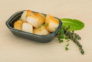 Grilled scallops on the plate and wooden background photo