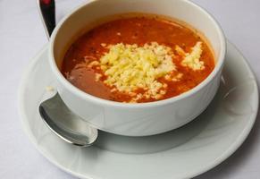 Tomato soup in a bowl on white background photo