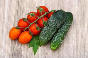 Cucumbers and tomatoes on the branch photo