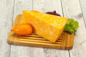 Marble cheese  triangle over wooden photo