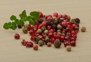 Pepper mix on wooden background photo