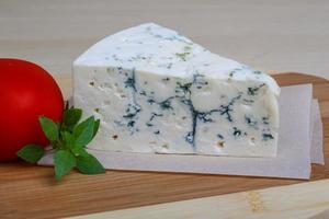 Blue cheese on wooden board and wooden background photo