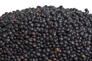 Heap of black lentil isolated on white photo