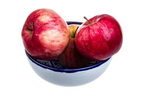 fresh red apples in the dish isolated on white background photo