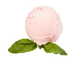 Scoop of strawberry ice cream from top on white background with mint photo