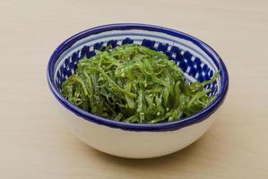 Chuka salad in a bowl on wooden background photo