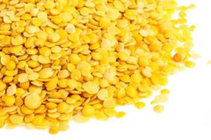 Yellow lentils isolated on white background. Macro shot photo