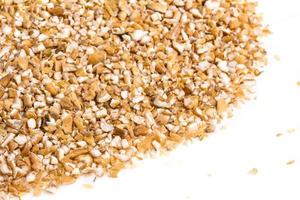 Pearl barley heap isolated on white photo